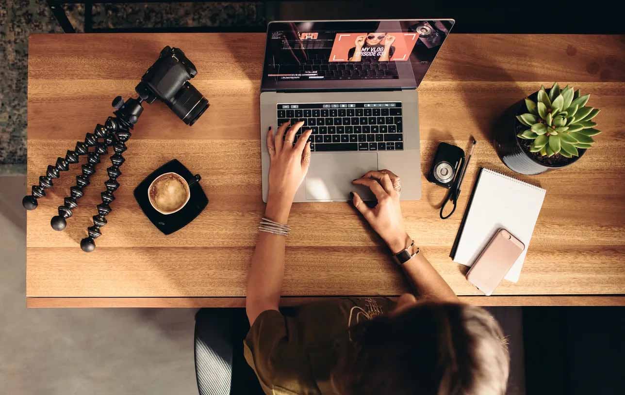  woman diligently working on her laptop at a desk, participating in a live digital marketing course with no recorded content.